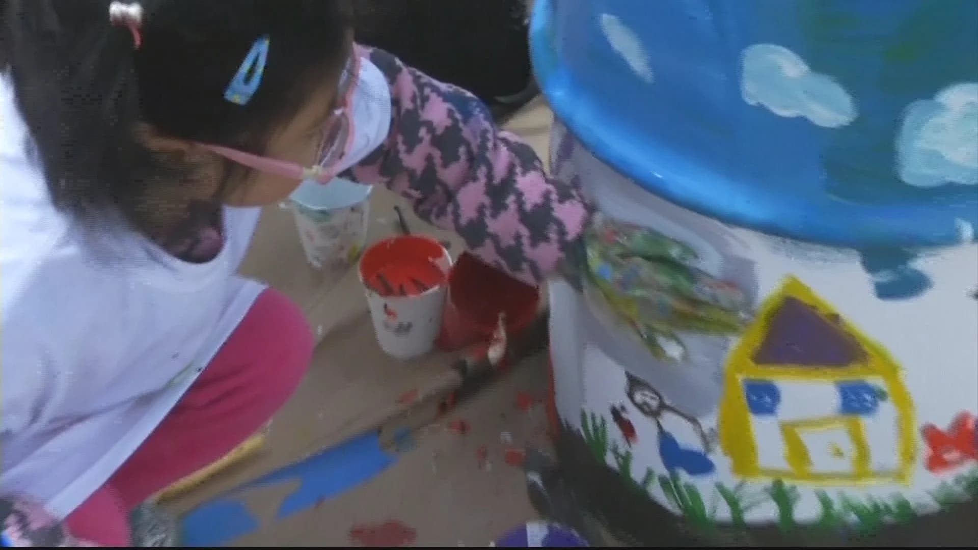 Community members decorate trash cans on Coney Island